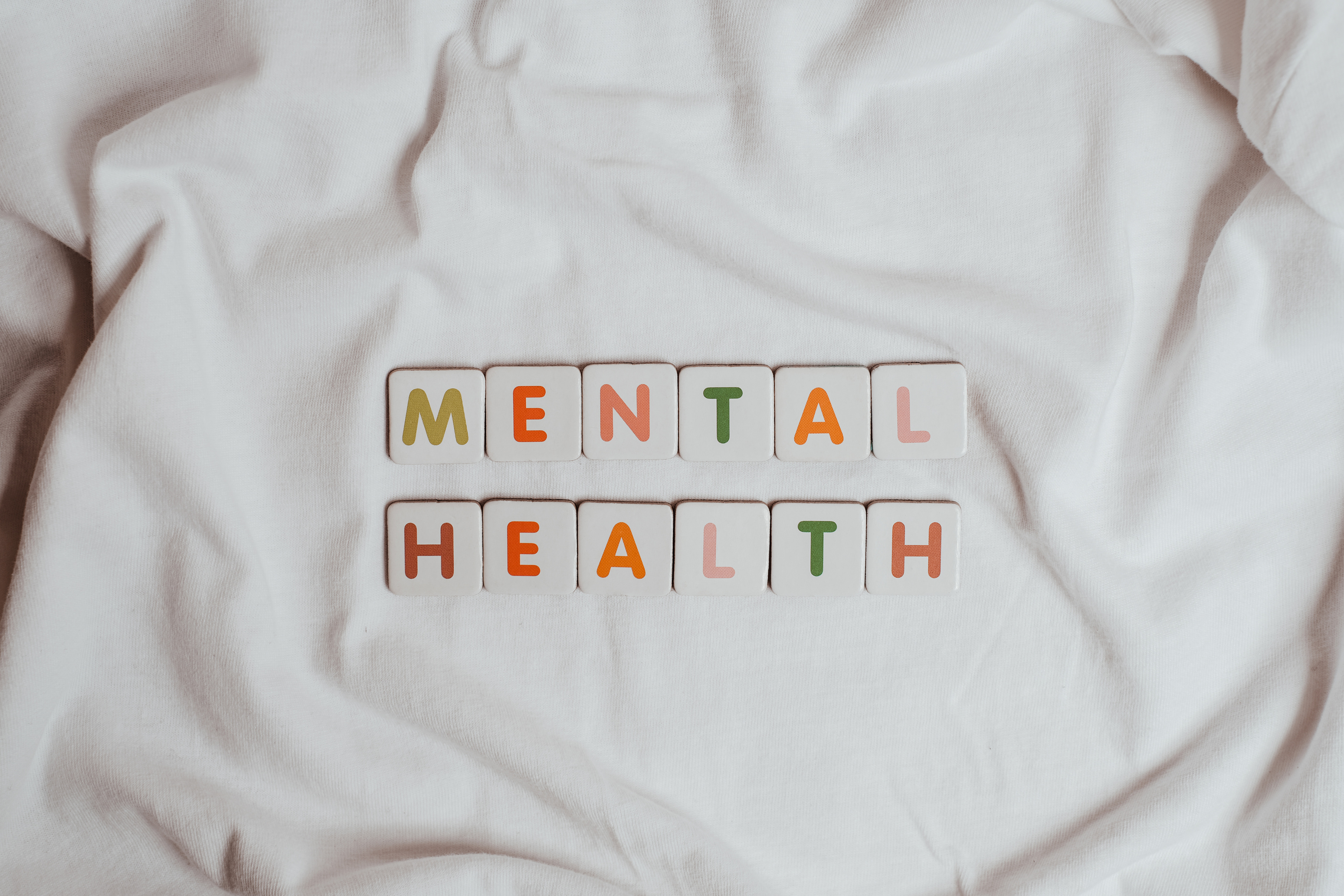 The Phrase Mental Health on a Sheet of Fabric